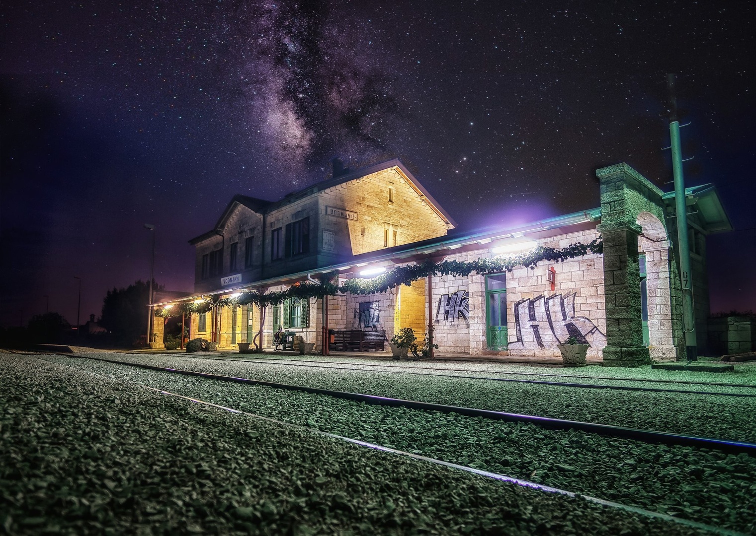 Train station under Milky way by Jure Murovec