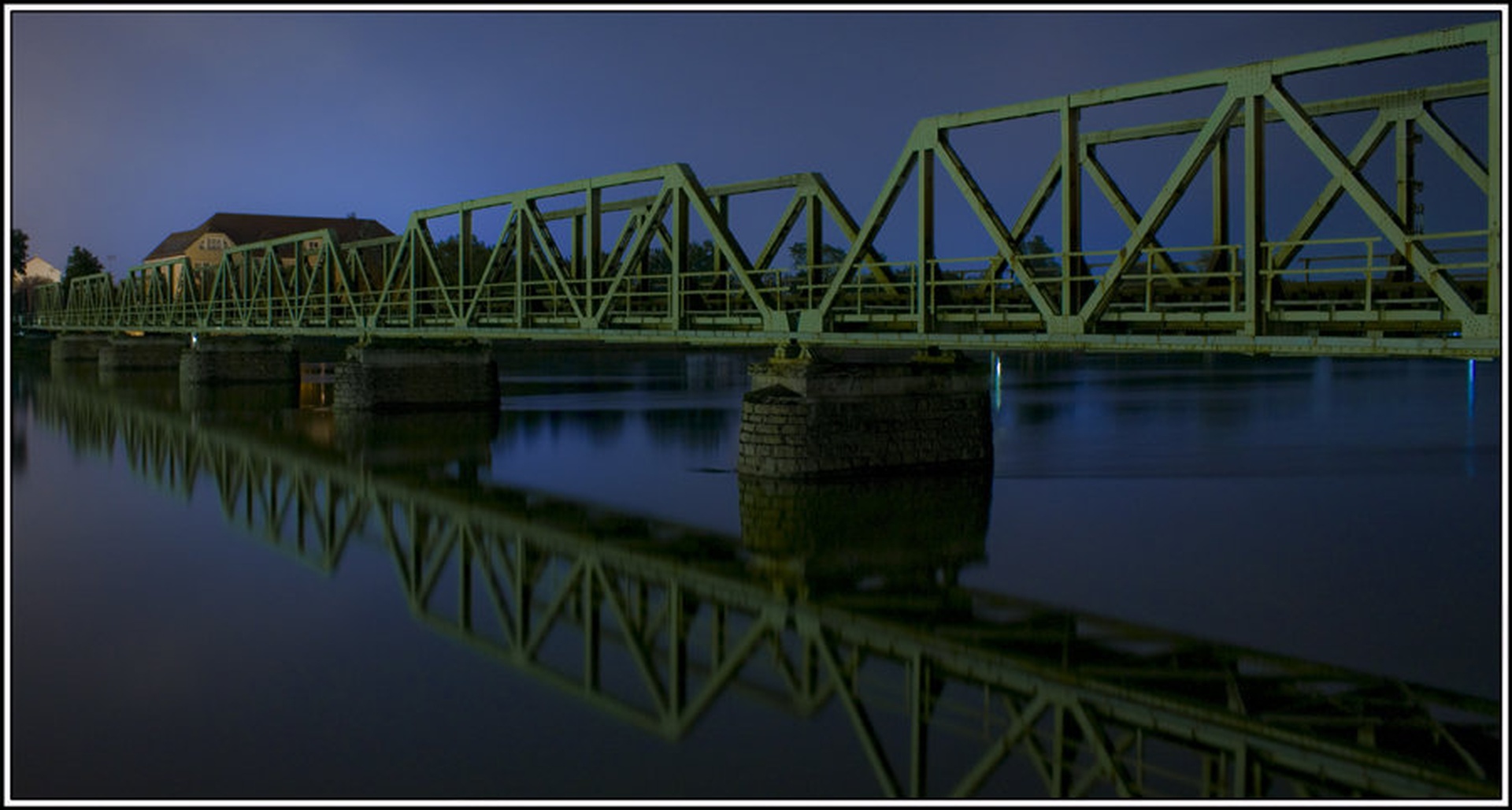 Mirrored bridge in night by Jani Bizjak