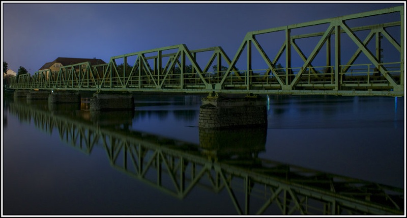 Mirrored bridge in night by Jani Bizjak