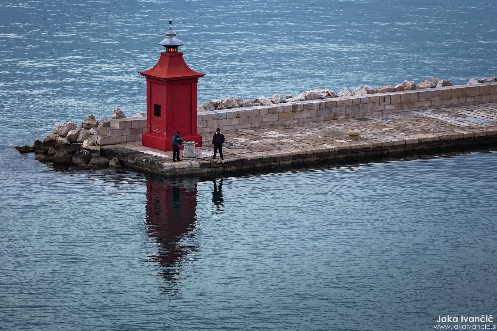 Fishing on the pier of Piran by Jaka Ivančič
